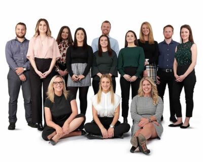 Australasian Recruitment Team Photo - People standing in businesswear smiling