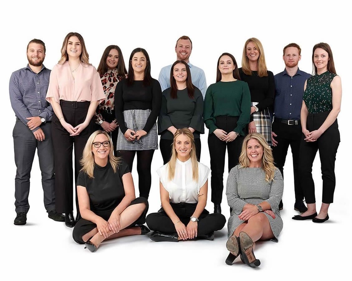 Australasian Recruitment Team Photo - People standing in businesswear smiling